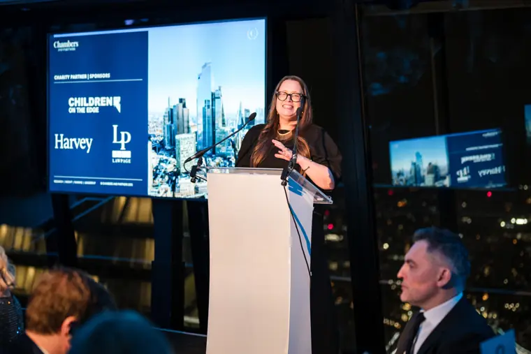 A speaker presenting the next award.