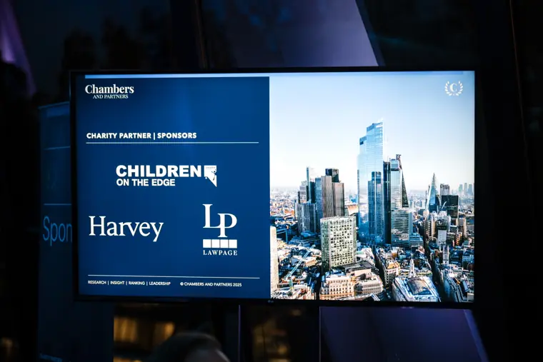 The charity partner screen above the stage.