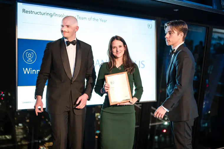 A winner accepting an award certificate.