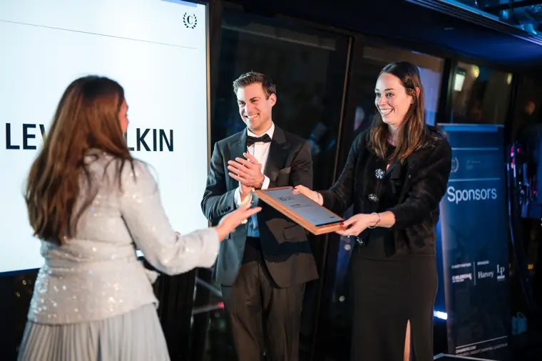 An award being presented on stage.