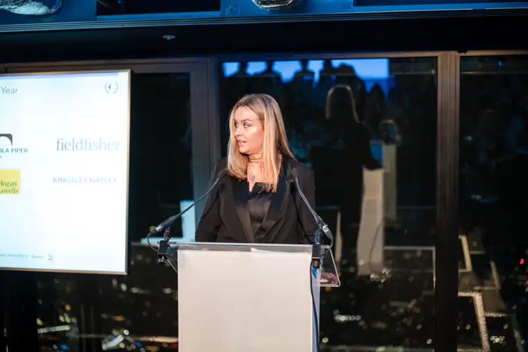 A woman speaking at the awards ceremony.