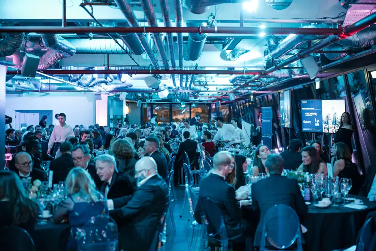 Guests filling the awards room beneath the city lights.