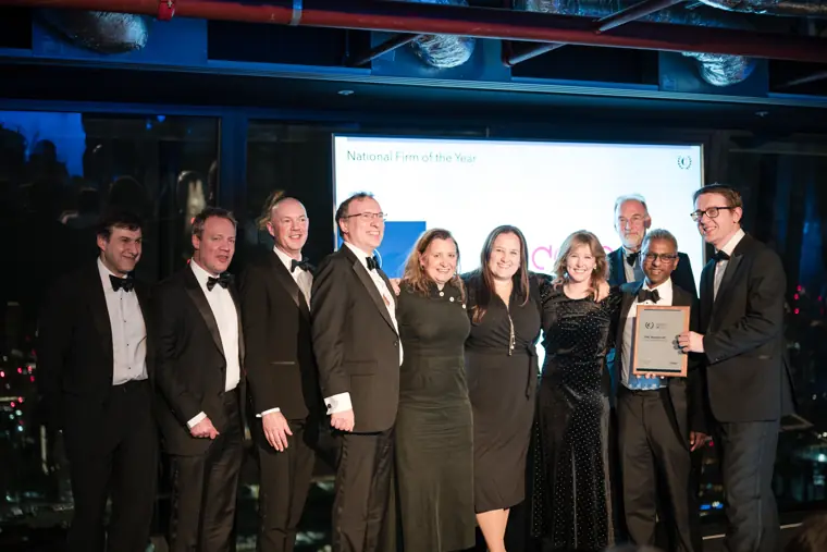 Award winners posing in front of the stage.