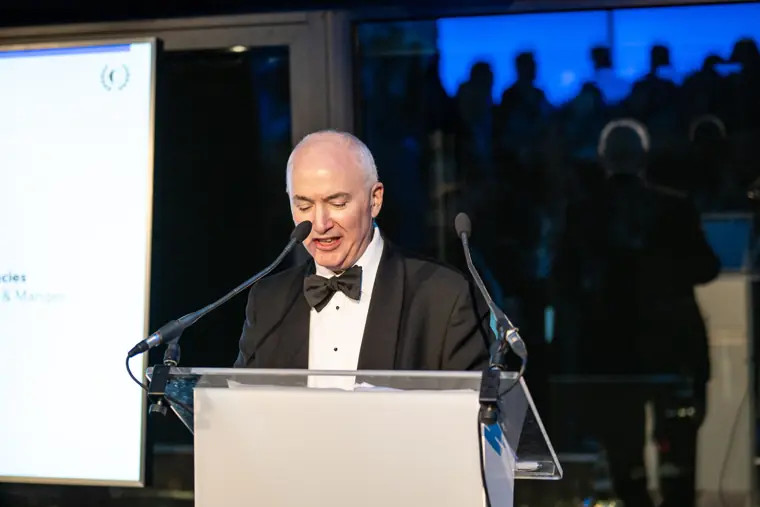 A speaker addressing guests from the lectern.