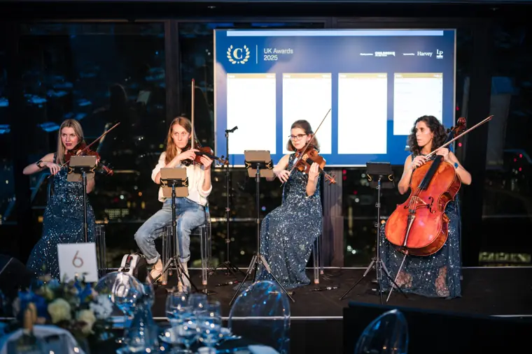 The string quartet performing beside the stage.