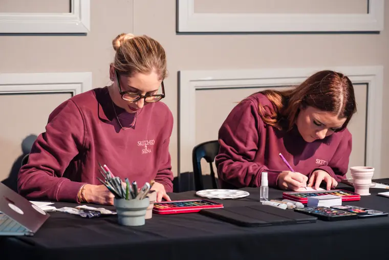 Artists sketching guests during the reception.