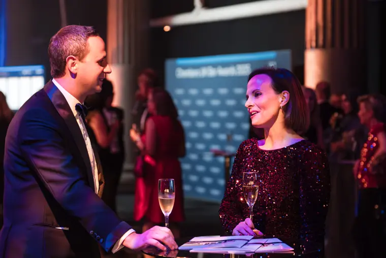 Guests talking over drinks at the welcome reception.