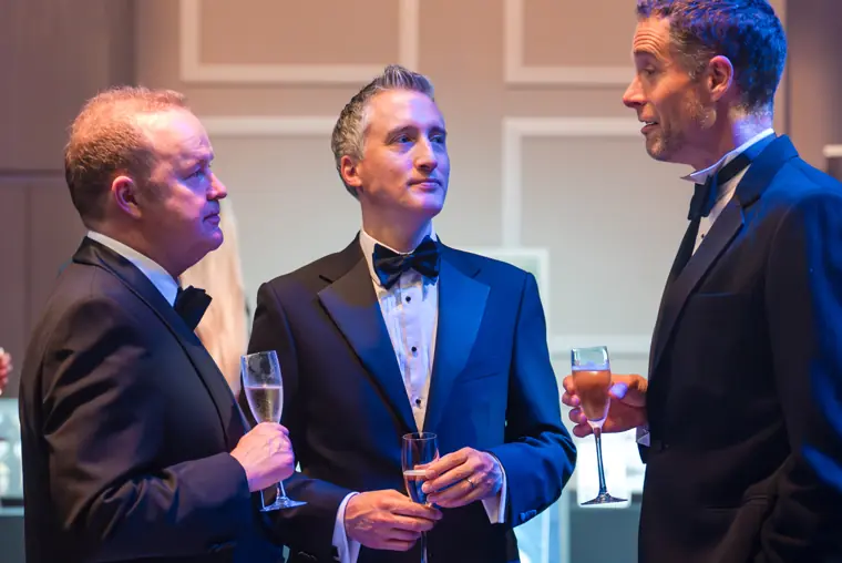 Three guests in conversation at the awards.
