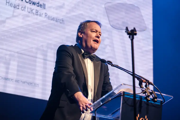 A presenter speaking to the room.
