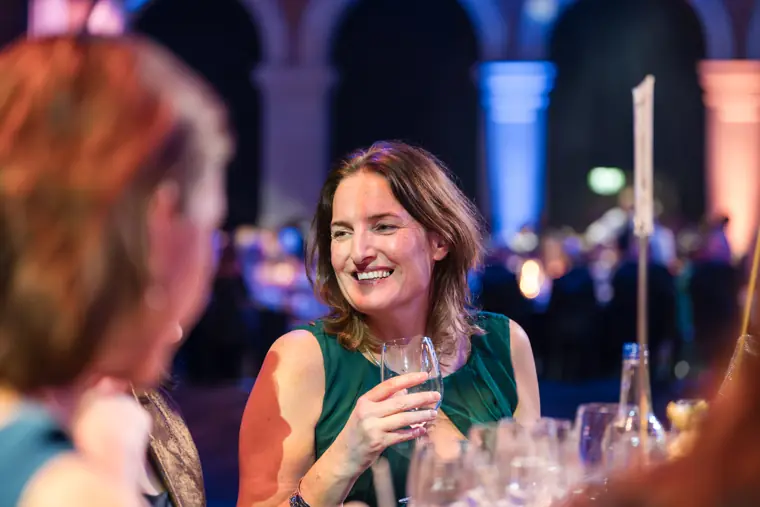 A guest enjoying a conversation at dinner.
