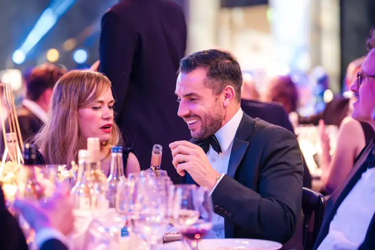 A pair of dinner guests sharing a conversation.