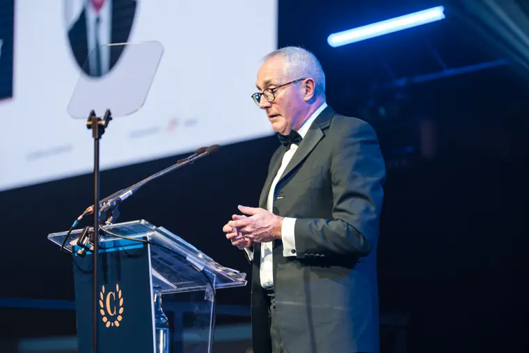 An award recipient speaking at the lectern.