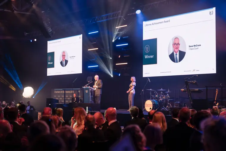 Guests applauding an award presentation.