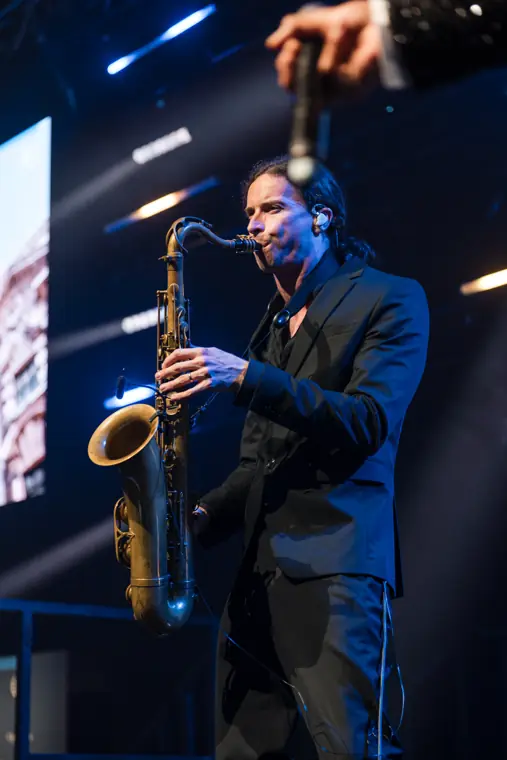 A saxophonist performing on stage.