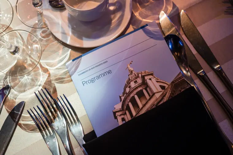 The printed awards programme beside a place setting.