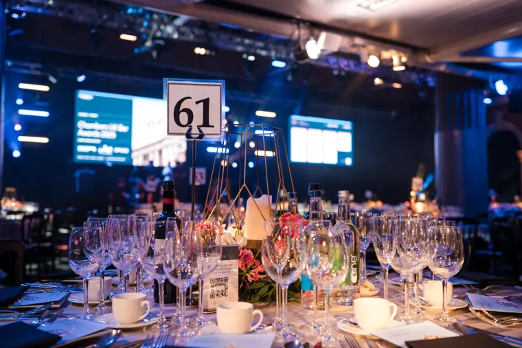 Dinner tables with the stage in the background.