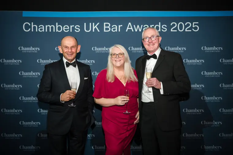 Three guests with a Chambers branded backdrop.