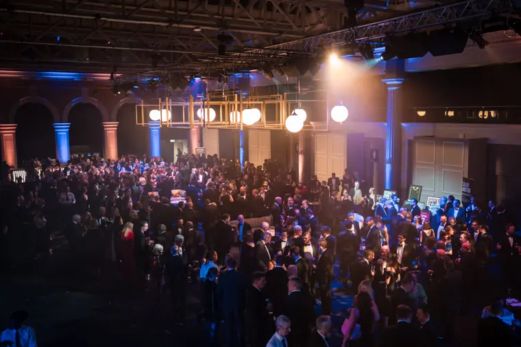 A packed audience applauding in the awards hall.