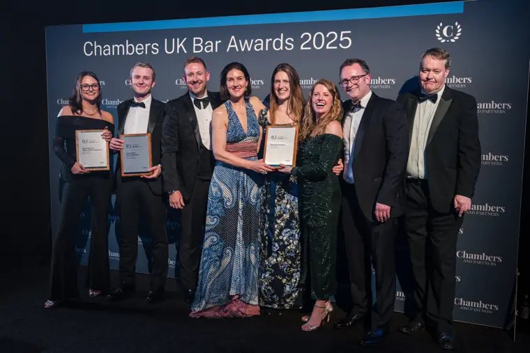 Award winners celebrating with certificates on stage.