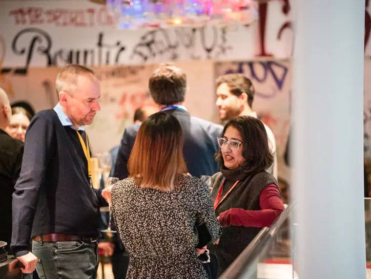 Guests networking during the ClickUp event.