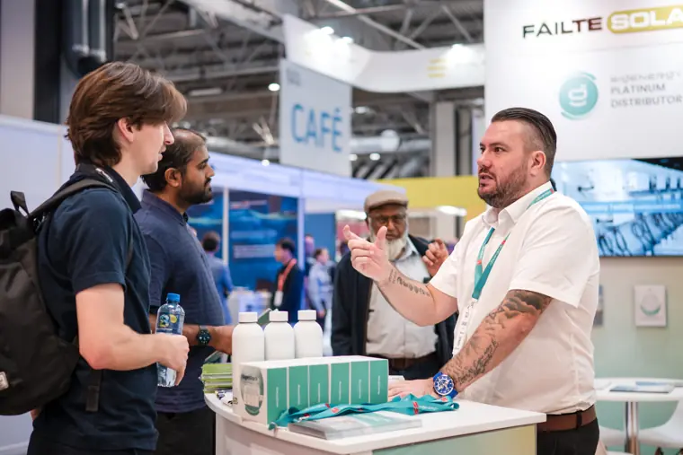 A team member explaining a product to a visitor.
