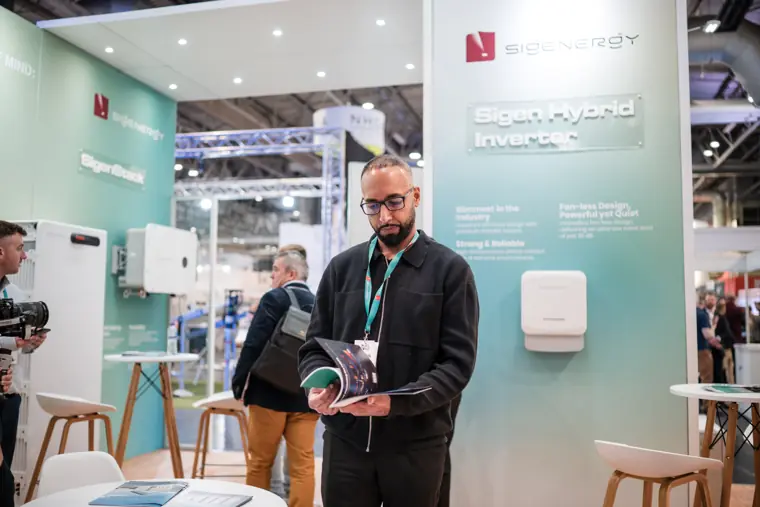 A team member standing beside the product wall.