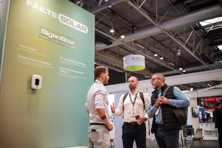 A handshake between visitors at the stand.