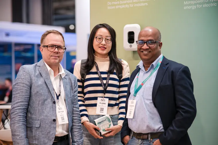 Three visitors photographed at the exhibition.