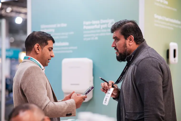 An attendee asking about the displayed equipment.