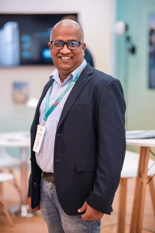 An exhibition portrait beside the stand.