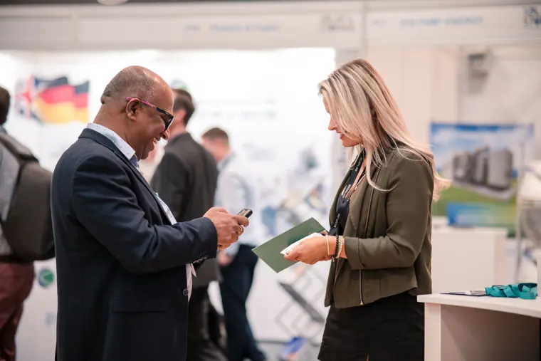 Two visitors discussing an information card.