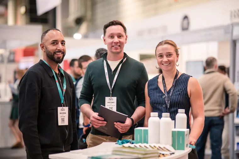 Three people smiling beside the Fáilte Solar stand.