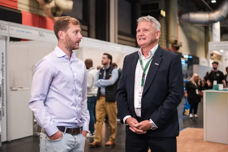 A conversation beside the exhibition stand.
