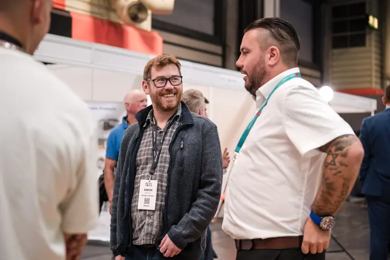 A team member talking with a visitor beside the counter.