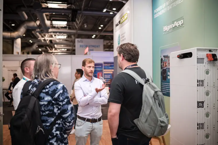 A conversation beside the Fáilte Solar product display.