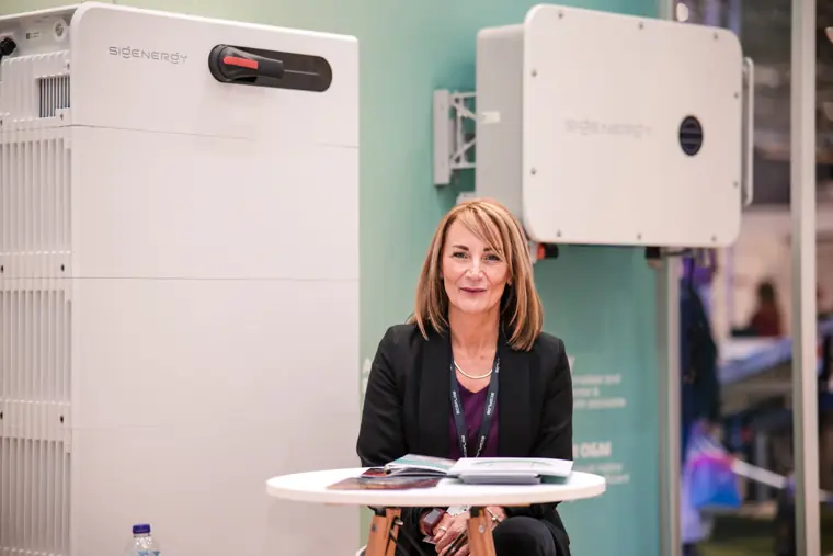 A team member photographed beside a display unit.