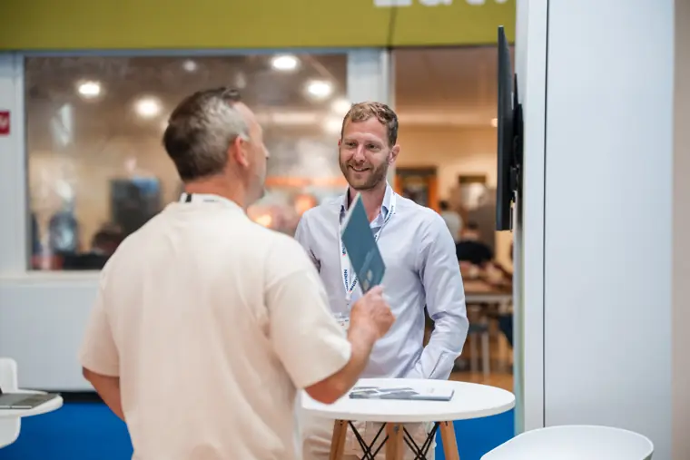 An attendee speaks with a member of the team.