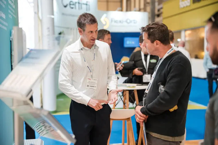 Two visitors listen to a Fáilte Solar representative.