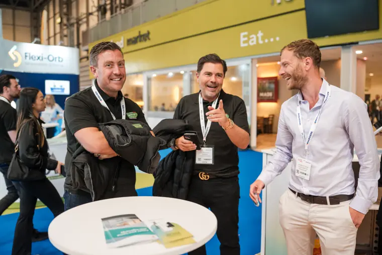 Visitors talk beside the exhibition counter.