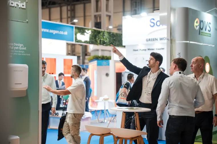 A product demonstration draws a group of visitors.