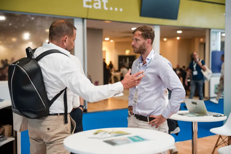 A visitor greets a representative across the counter.