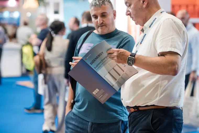 Visitors look through a product brochure together.