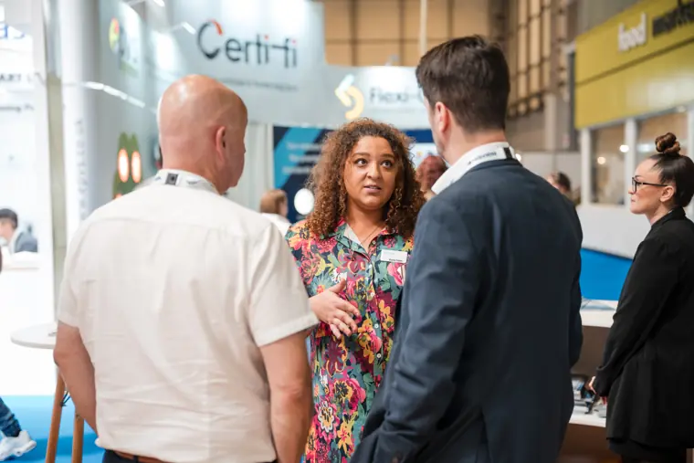 Visitors meet beside the neighbouring exhibition stand.