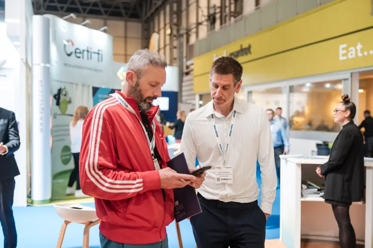 A representative shows information to a visitor.
