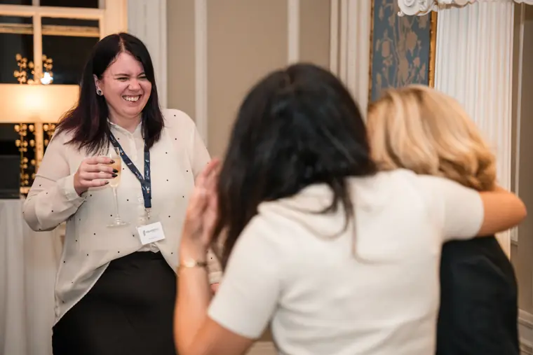 Guests greeting one another in the private dining room.