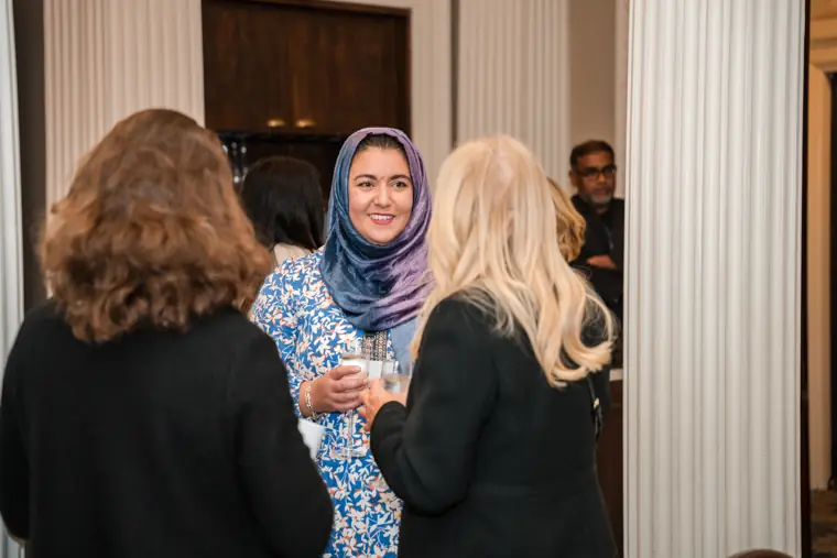 Women connecting before the seated programme.