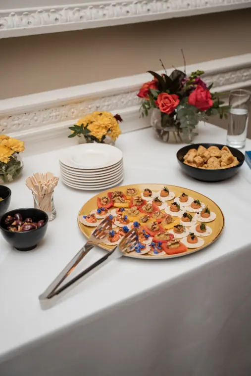 Canapés and flowers set out for the gathering.