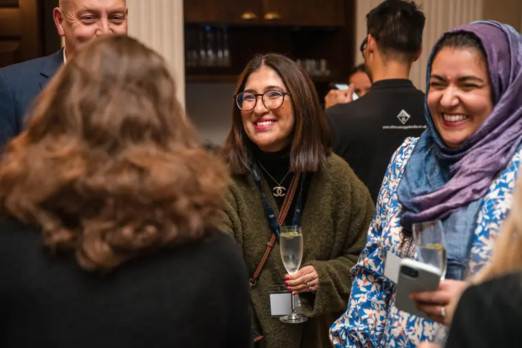 Guests exchanging a smile at the event.