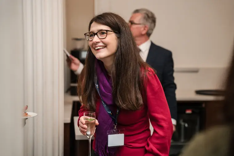 Attendee smiling during the reception.