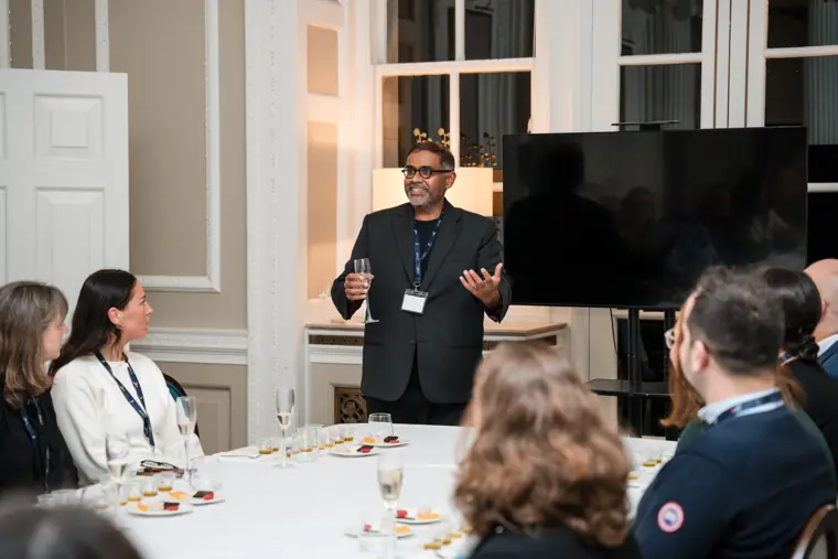 Speaker addressing guests at the table.